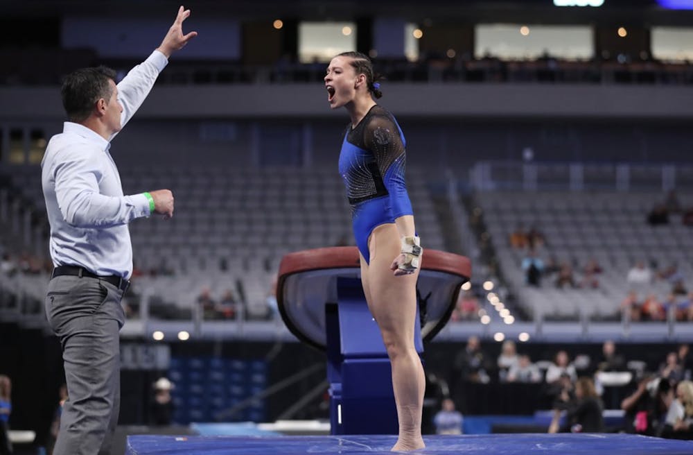 <p>Gators gymnast Megan Skaggs celebrates with assistant coach Adrian Burde. Burde was promoted to associate head coach Friday. Photo courtesy of the UAA // Courtney Cullbreath.</p>