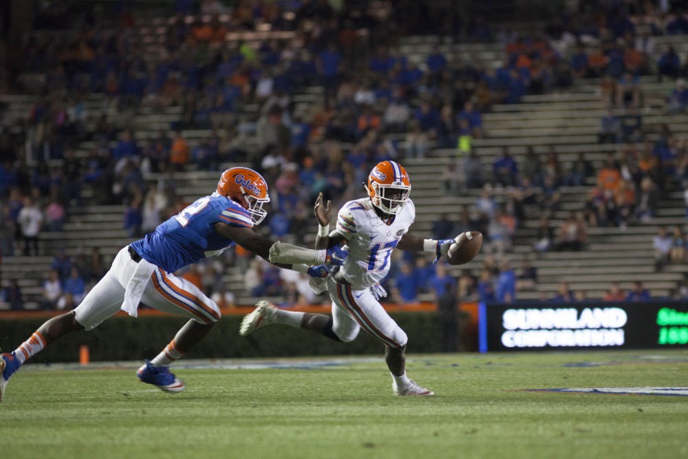 Quarterback Kadarius Toney evades a defender during Florida's Spring football game on April 7, 2017. 