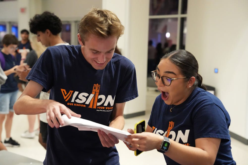 <p>Members of Vision Party look over the election results in the J. Wayne Reitz Union Student Union Reitz Student Union on Wednesday, Oct. 4, 2023. </p>