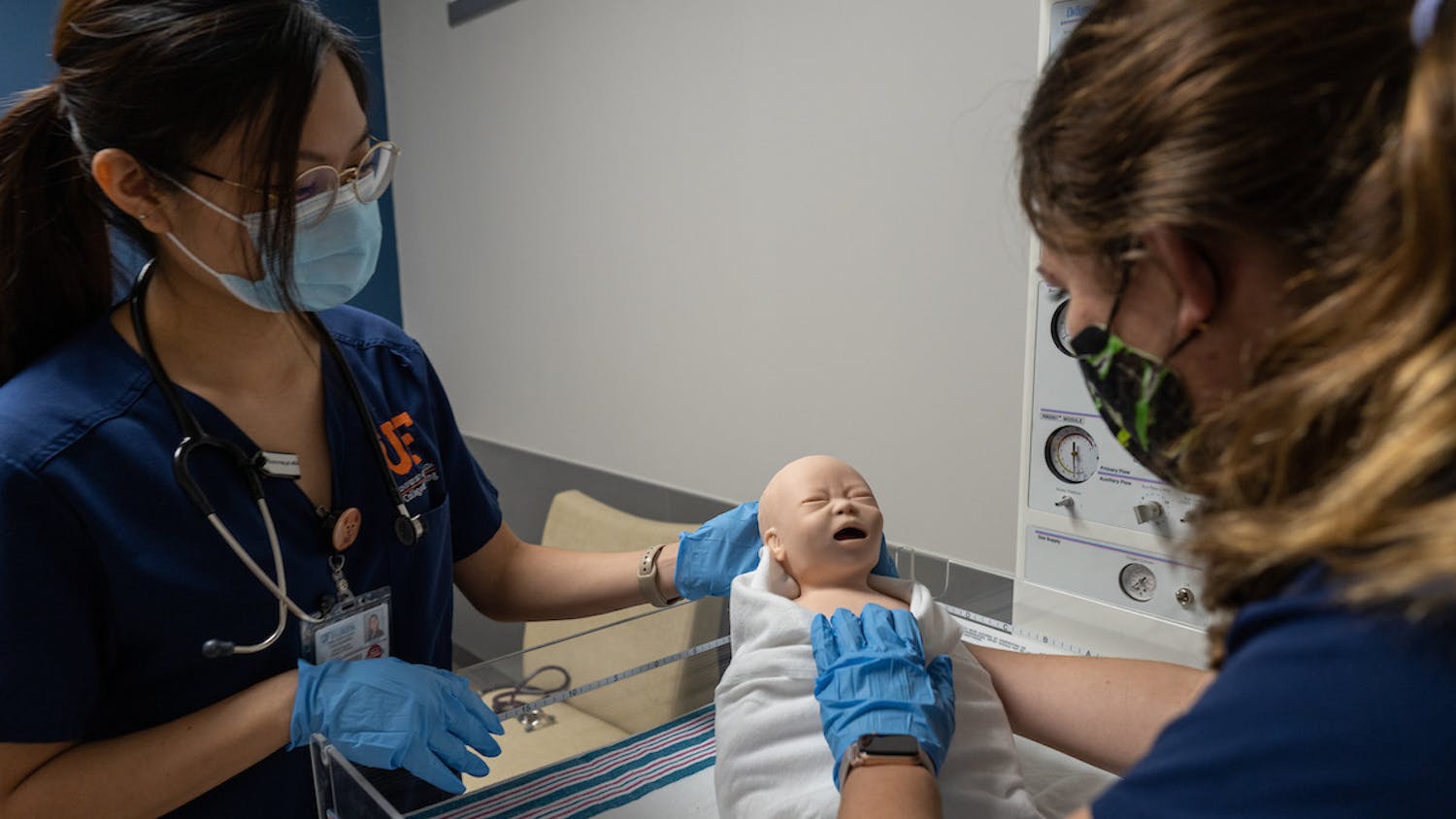 Two UF nursing students carrying out newborn assessment in one of the new simulation rooms at the College of Nursing. [Courtesy of Jesse Jones]