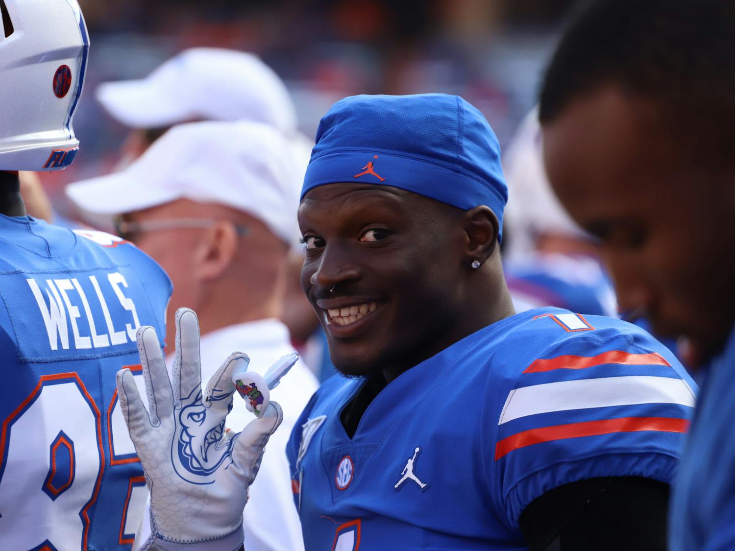 Kadarius Toney holds his Joker-themed mouth guard in his right hand as he waves at the camera during Florida&#x27;s game against Vanderbilt on Nov. 9, 2019.
