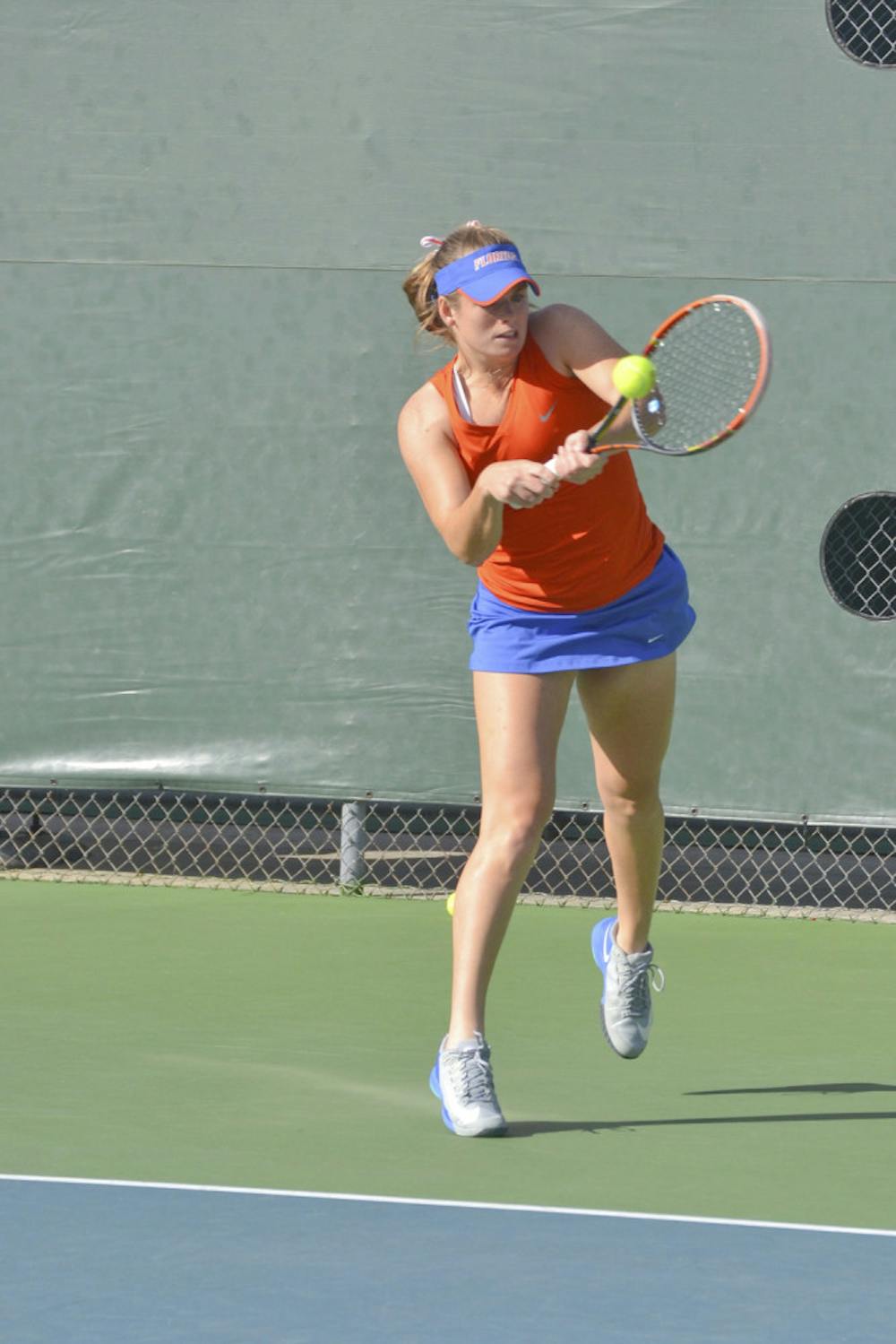 <p>Belinda Woolcock hits a two-handed backhand during Florida's 4-0 win against Elon on Jan. 24, 2015.</p>