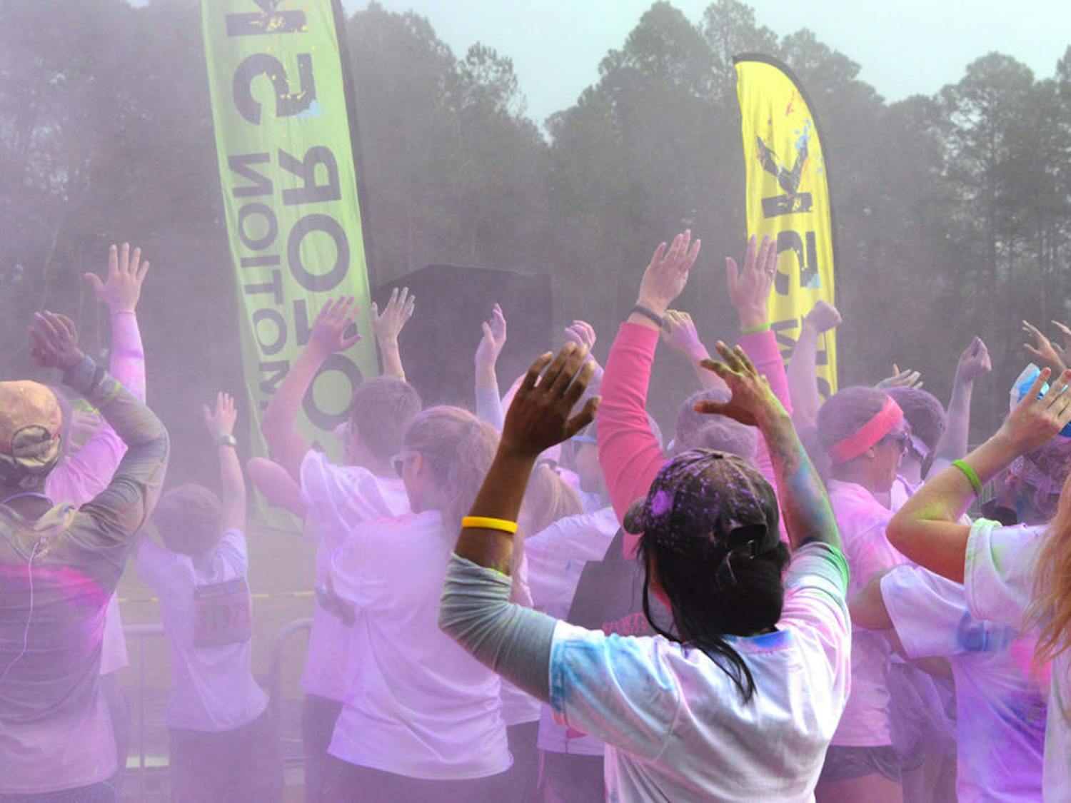 Runners dance to music performed by DJ James Phabulous at the end of 5K. About 500 people participated in the color run at the Alachua County Fairgrounds on Jan. 16, 2016.