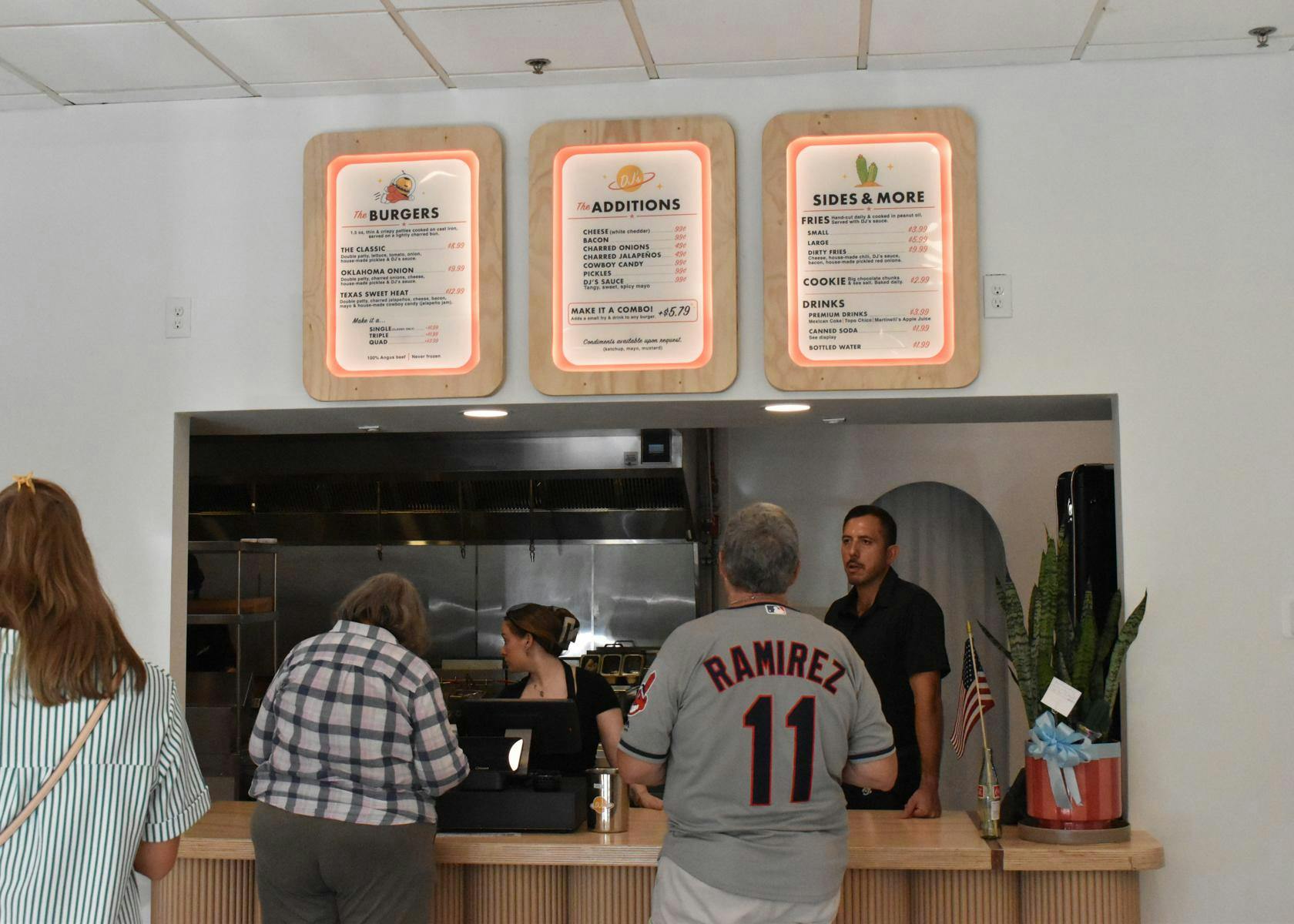 Customers look over the menu of DJ's Cast Iron Burgers Wednesday, July 8, 2026 in Gainesville, Fla.