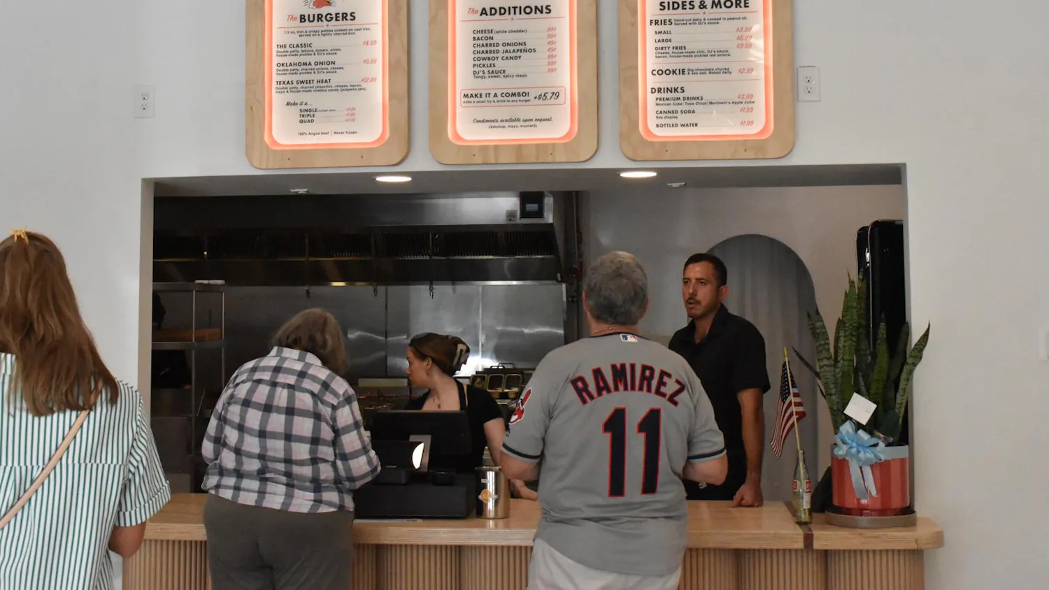 Customers look over the menu of DJ's Cast Iron Burgers Wednesday, July 8, 2026 in Gainesville, Fla.