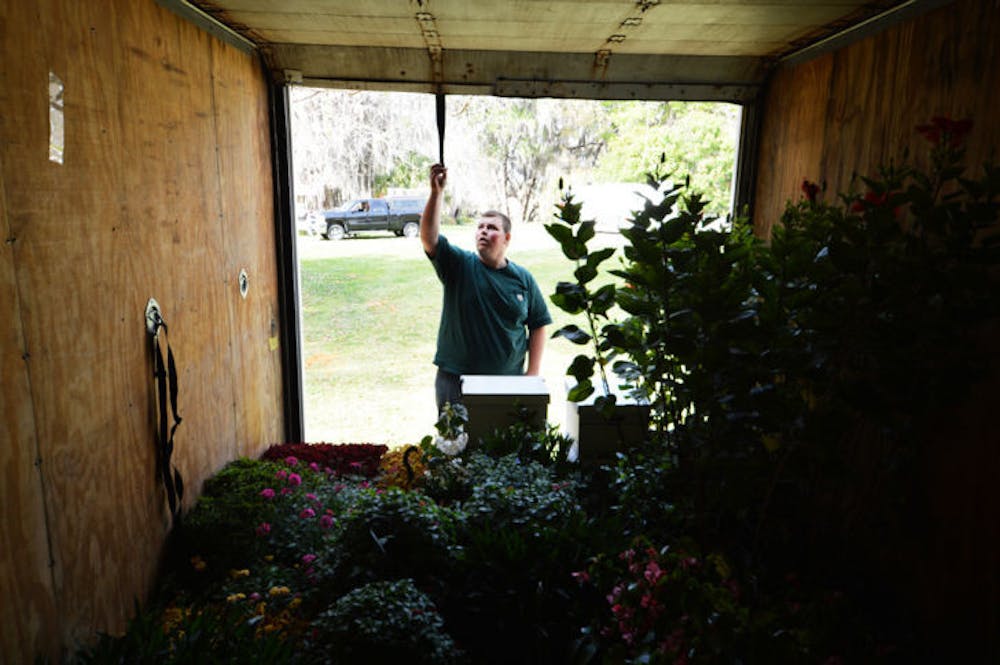 <p>J.R. Trimm, 16, of Bronson, loads plants to his box truck at the Kanapaha Botanical Gardens on Thursday afternoon. This weekend is the Spring Festival at the gardens, located at 4700 SW 58th Drive.</p>