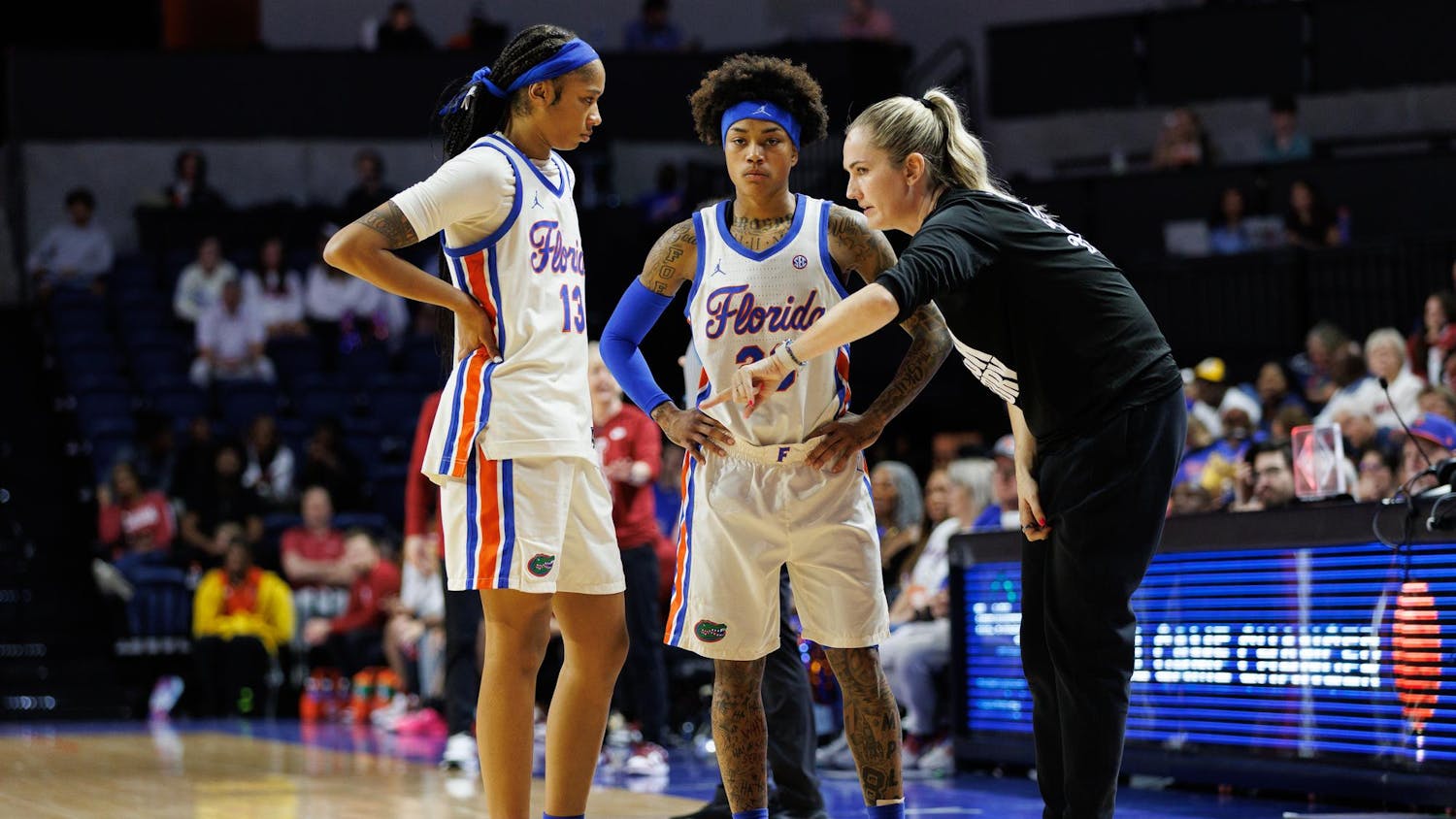 Florida guard Laila Reynolds (13) and guard Liv McGill (23) talk with Florida head coach Kelly Rae Finley during the third quarter of an NCAA basketball game against Alabama, Sunday, Feb.22, 2026, in Gainesville, Fla.