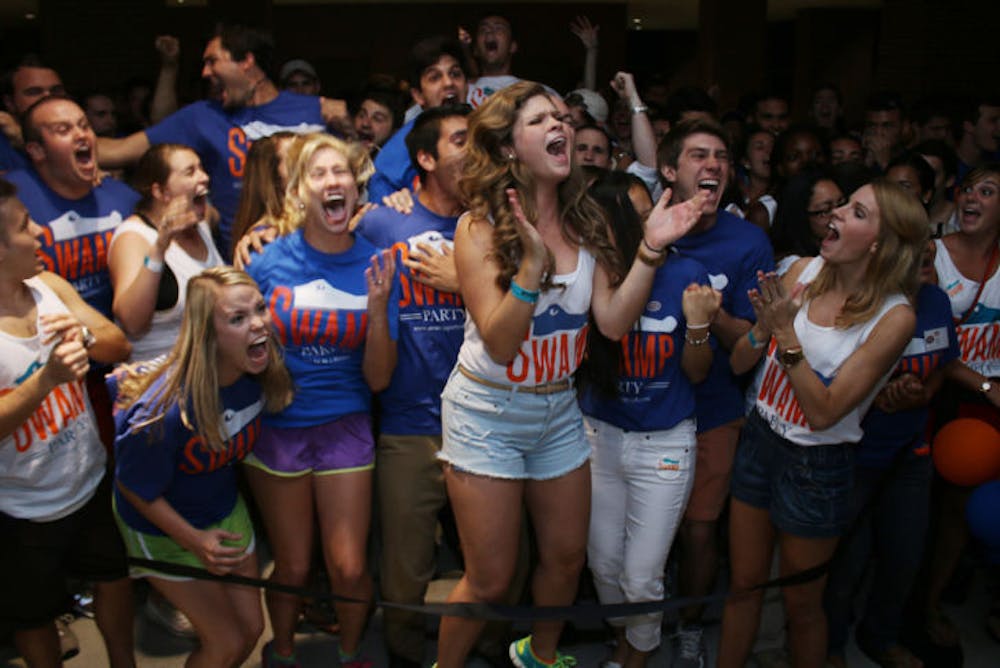 <p>Senate President Lauren Verno, center, and other Swamp Party members celebrate winning 48 out of 50 seats in the Fall election Wednesday evening in the Reitz Union breezeway.</p>