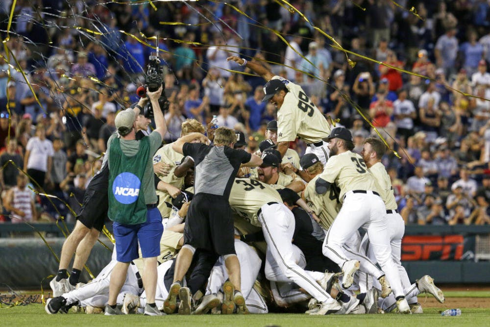 FILE - In this June 26, 2019, file photo, Vanderbilt players celebrate winning Game 3 and the champinship of the NCAA College World Series baseball finals against Michigan in Omaha, Neb. If not for the coronavirus pandemic, there would have been a World Series championship series Omaha, Nebraska. (AP Photo/Nati Harnik, File)