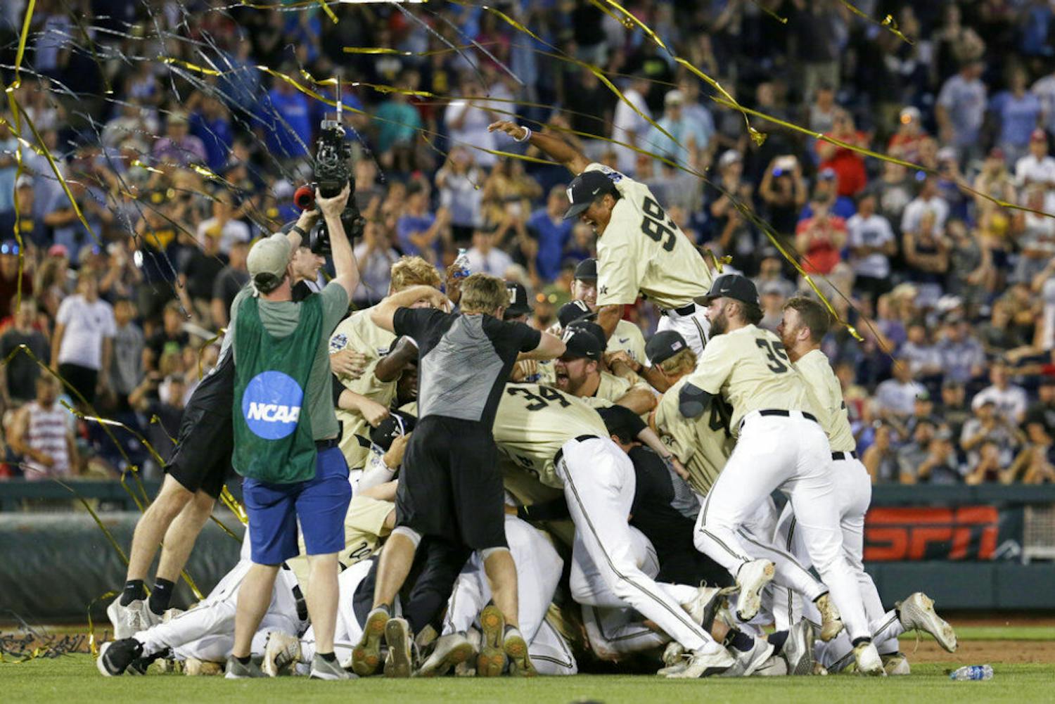 FILE - In this June 26, 2019, file photo, Vanderbilt players celebrate winning Game 3 and the champinship of the NCAA College World Series baseball finals against Michigan in Omaha, Neb. If not for the coronavirus pandemic, there would have been a World Series championship series Omaha, Nebraska. (AP Photo/Nati Harnik, File)