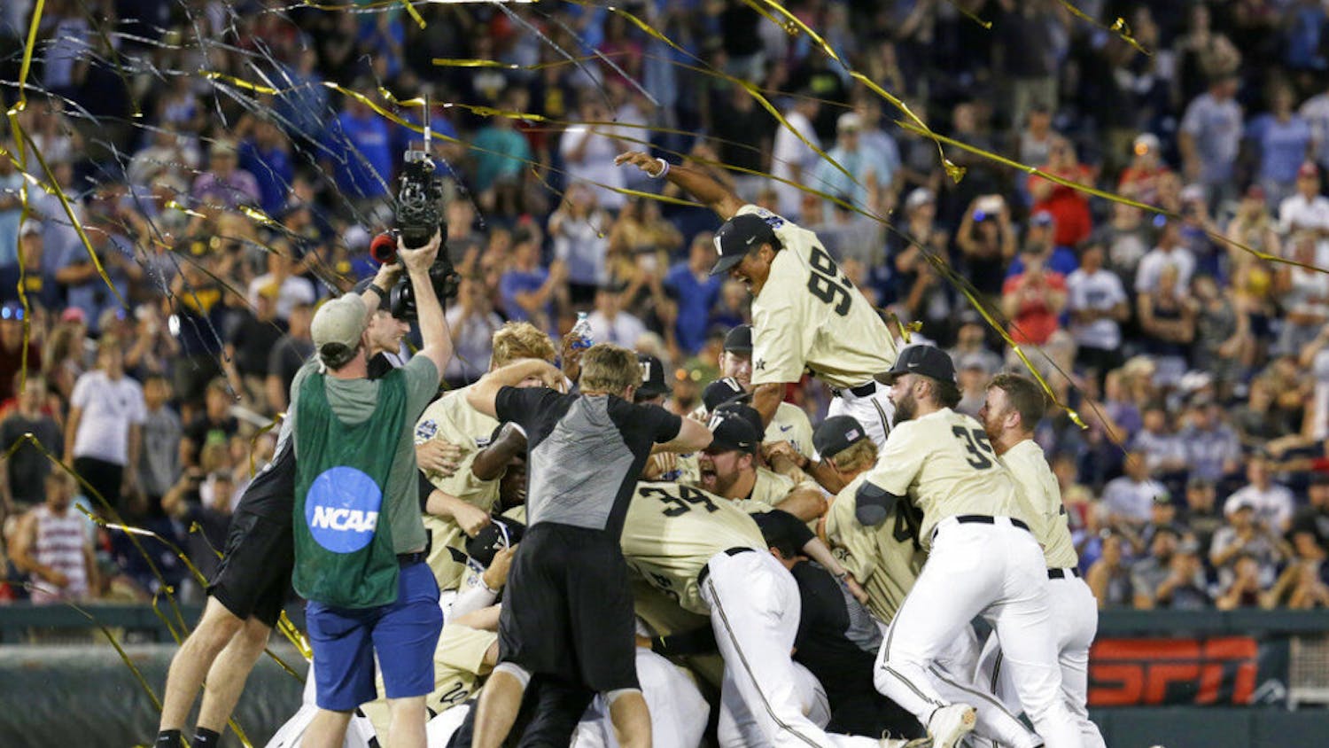 FILE - In this June 26, 2019, file photo, Vanderbilt players celebrate winning Game 3 and the champinship of the NCAA College World Series baseball finals against Michigan in Omaha, Neb. If not for the coronavirus pandemic, there would have been a World Series championship series Omaha, Nebraska. (AP Photo/Nati Harnik, File)