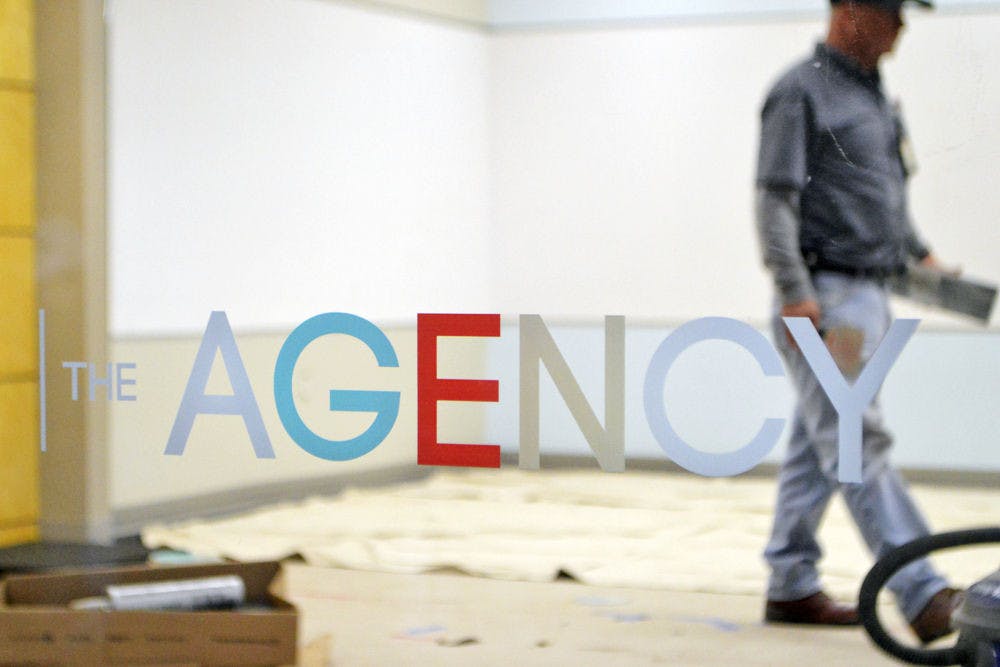 A worker walks through the construction site of The Agency, located on the first floor of Weimer Hall, on Thursday afternoon.