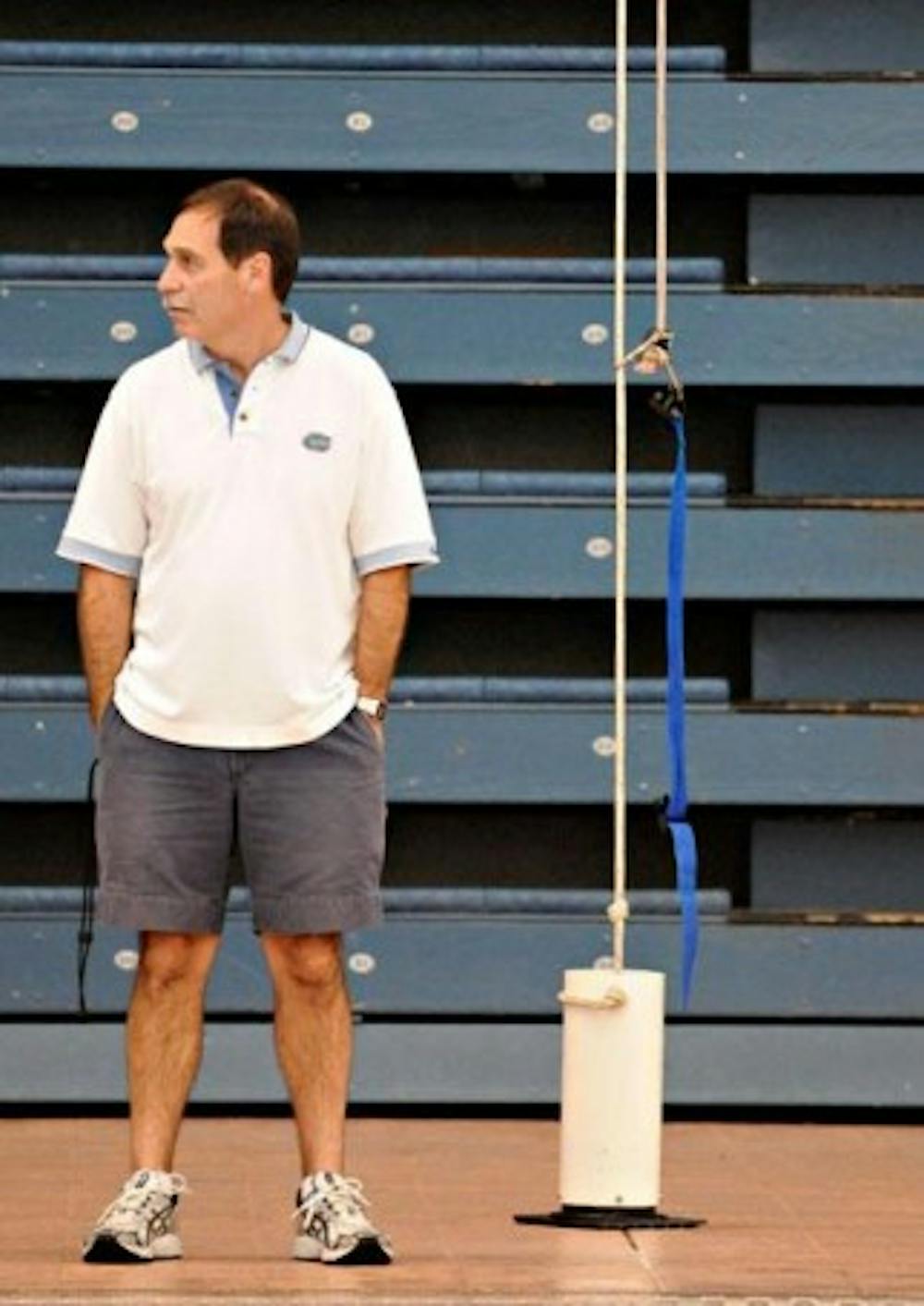 <p>UF swim coach Gregg Troy watches his team's weight training at an early morning practice in the O'Connell Center on Feb. 7, 2008.&nbsp;</p>