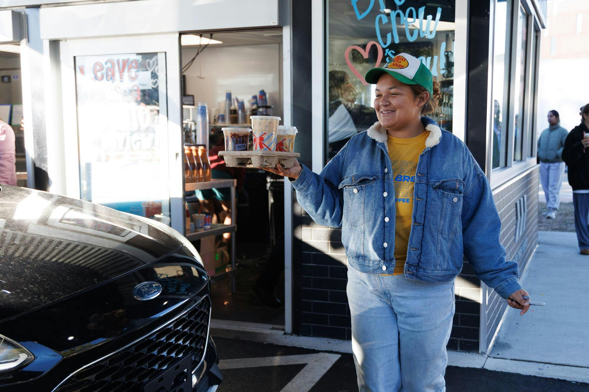7 Brew Coffee employee Lauryn Miller walks out a customer’s order at their new location in Gainesville, Fla., Friday, Jan. 16, 2026.