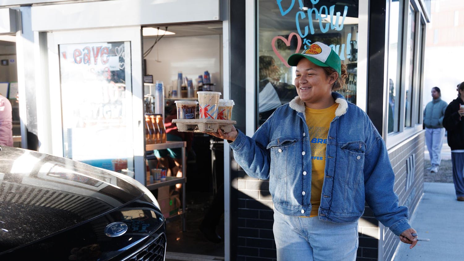 7 Brew Coffee employee Lauryn Miller walks out a customer’s order at their new location in Gainesville, Fla., Friday, Jan. 16, 2026.
