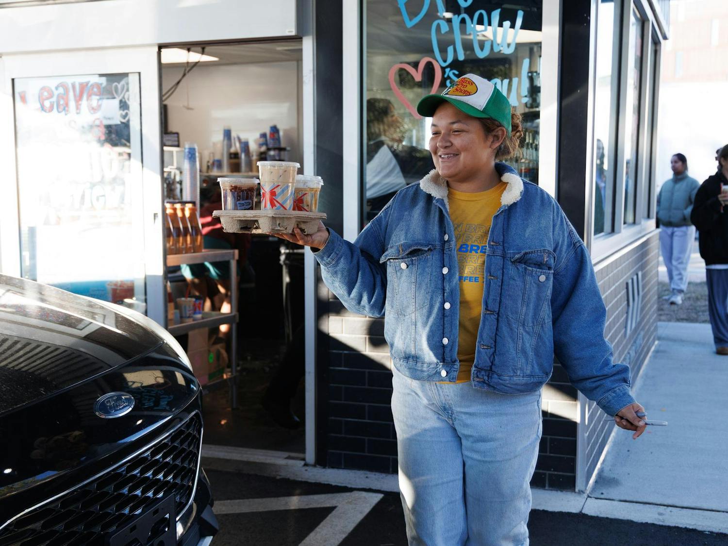 7 Brew Coffee employee Lauryn Miller walks out a customer’s order at their new location in Gainesville, Fla., Friday, Jan. 16, 2026.