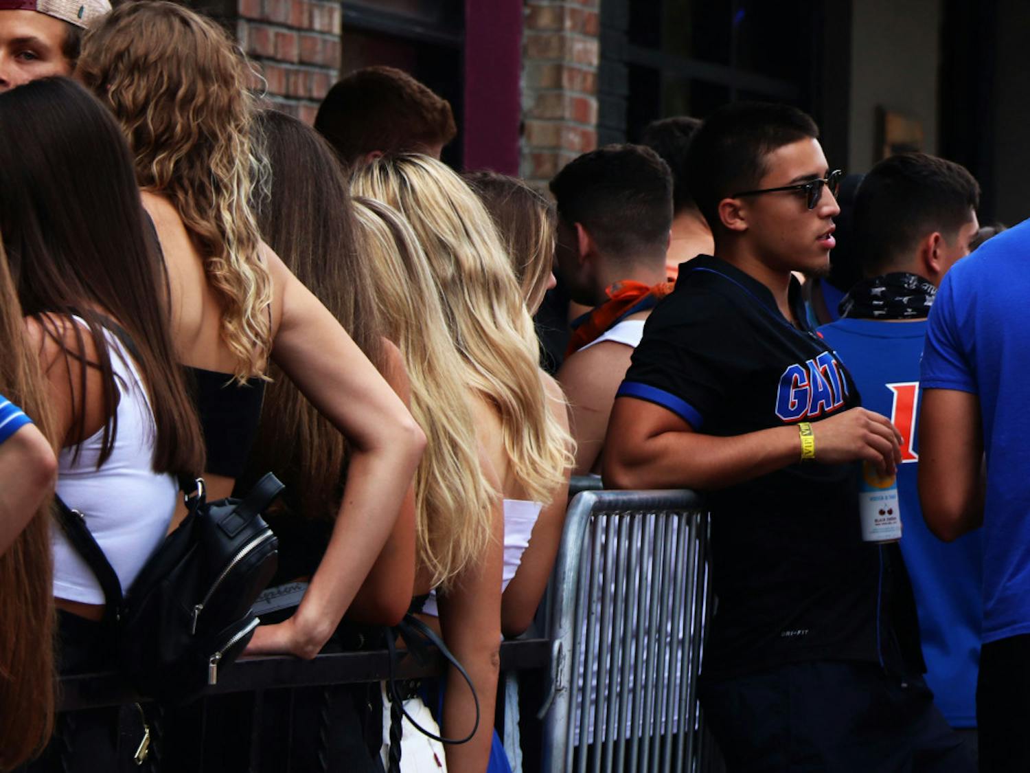 A person is seen standing by the crowded line to enter DownTown Fats, located on S Main St, on Saturday, Oct. 3, 2020, during the first home football game of the season. (Chasity Maynard/Alligator Contributor)