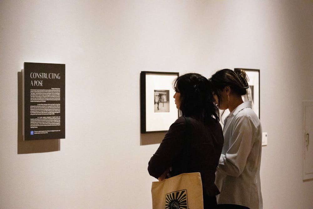 <p>Attendees walk through the “Posing Beauty in African American Culture” exhibit Thursday, Feb. 9, 2023.</p>