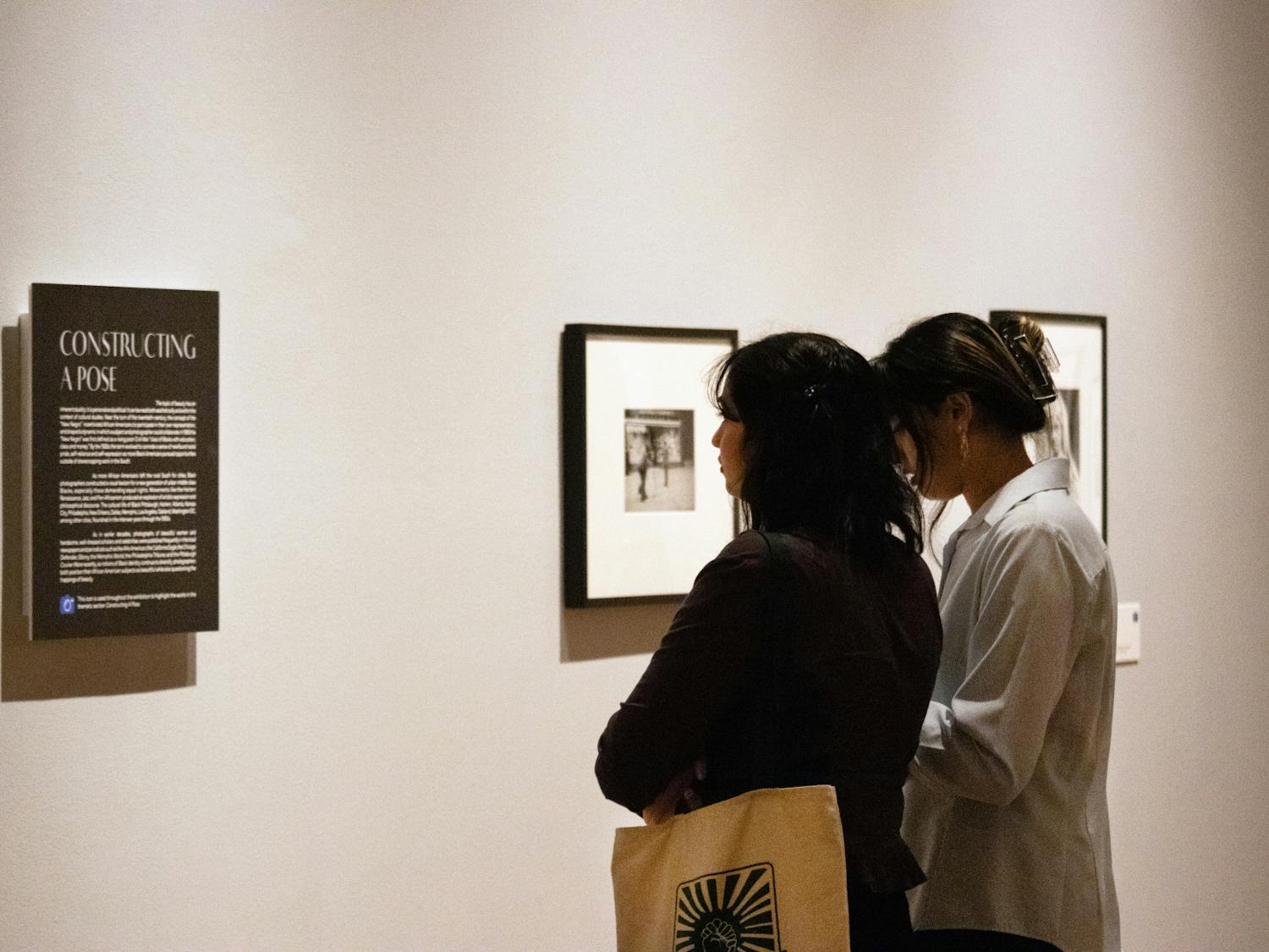 Attendees walk through the “Posing Beauty in African American Culture” exhibit Thursday, Feb. 9, 2023.