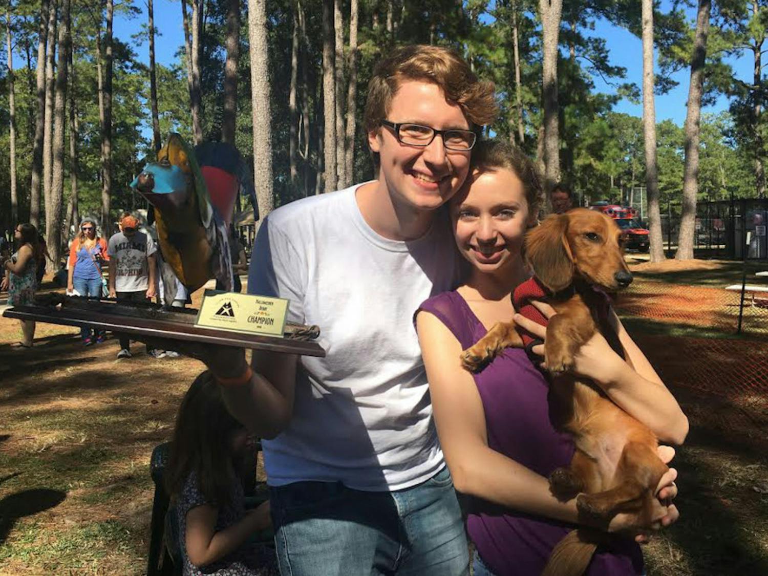 Adam Ray, a UF biology junior, poses with his 9-month-old Dachshund Bowie following the dog's first-place win in Sunday's Halloweener Derby. The second annual Dachshund-only race, held at Westside Park, raised about $5,000 for the pediatric oncology unit at UF Health Shands Hospital.