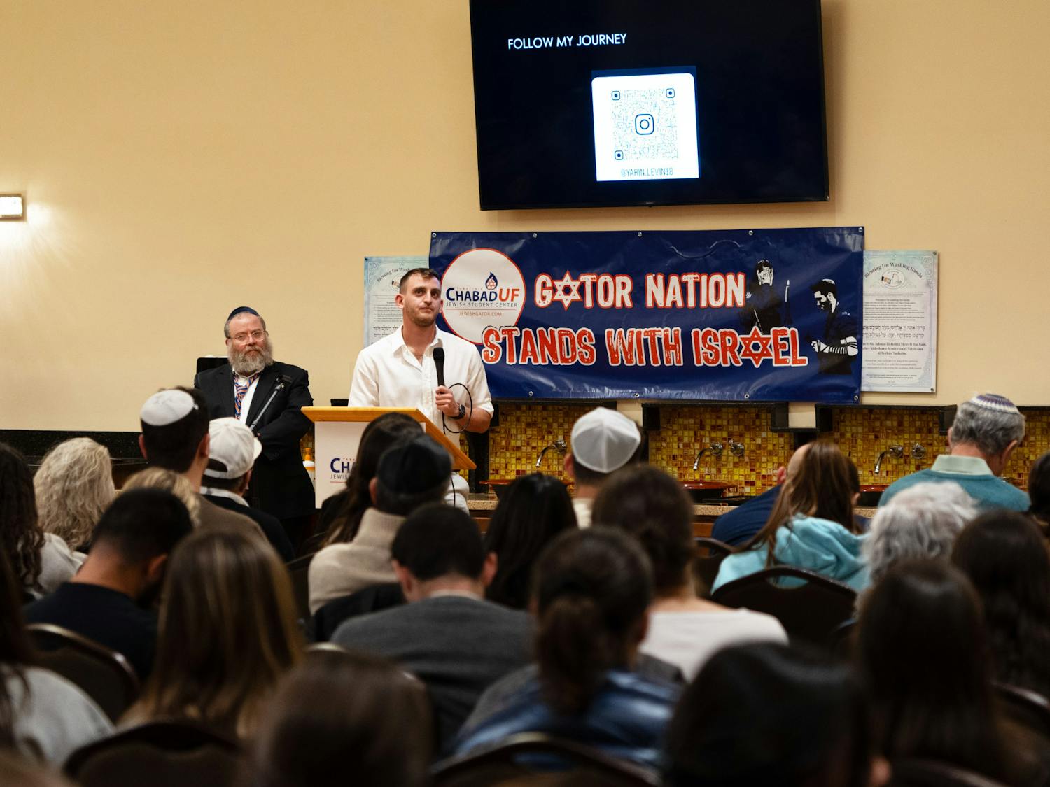 Yarin Levin answers the crowds questions after sharing his story about the Nova Festival at the Chabad UF Jewish Student & Community Center on Tuesday, Nov. 28, 2023.