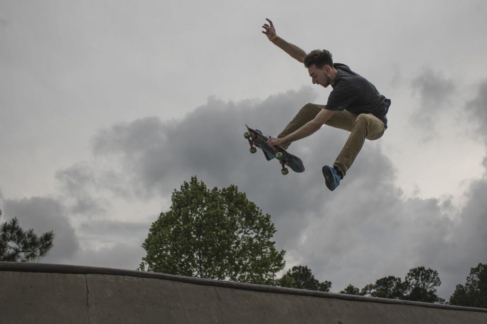 Paul Austin, a 21-year-old UF veterinary medicine student, performs a trick on his skateboard Tuesday evening at Possum Creek Park, 4009 NW 53rd Ave. Austin works full time as the head assembly technician specialist at Fabco-Air, Inc. and takes all of his classes online, but he said he tries to practice skating at least two or three times per week. “It’s my way to get out and be free,” Austin said. “It’s like flying to me.”