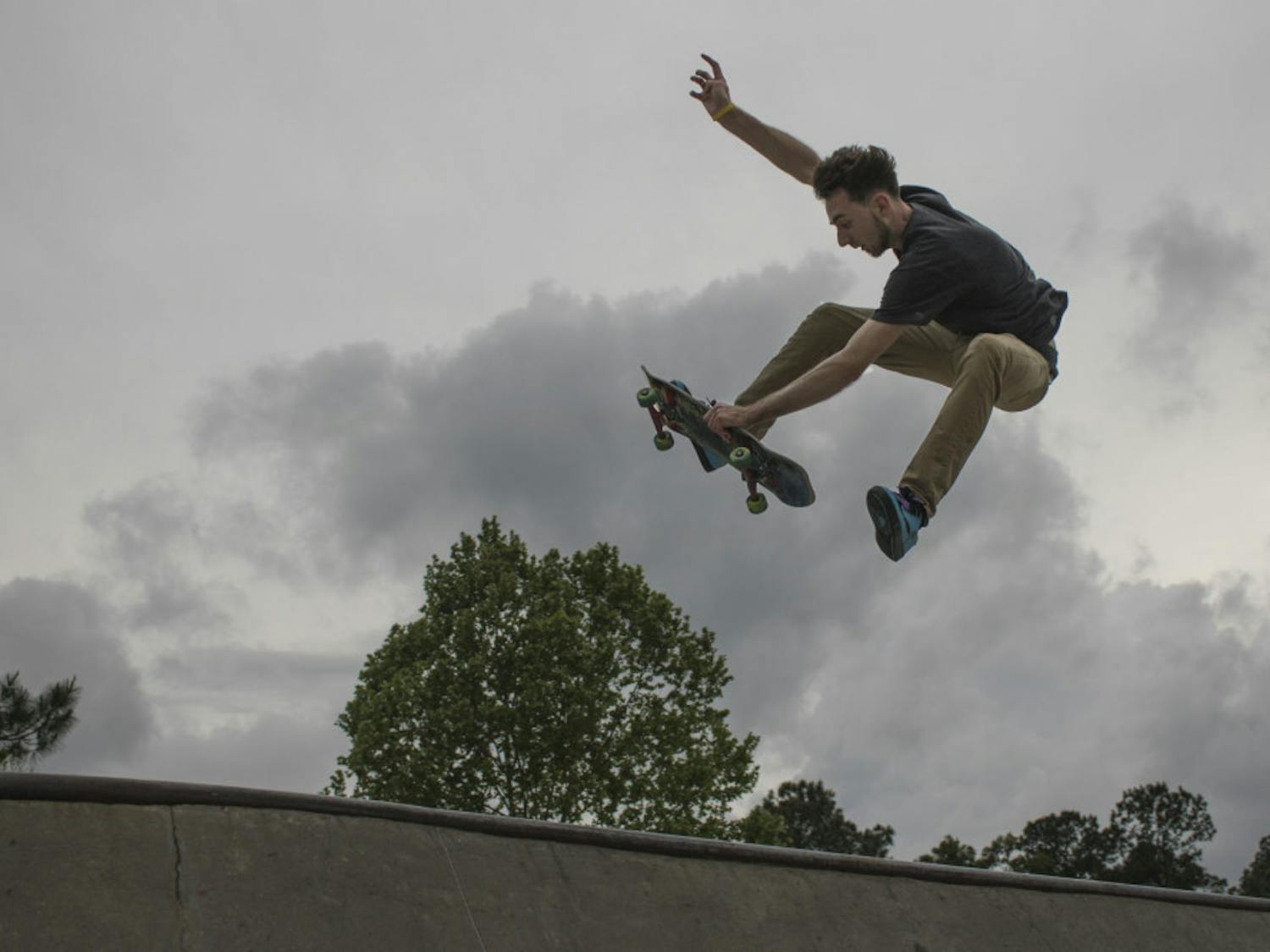 Paul Austin, a 21-year-old UF veterinary medicine student, performs a trick on his skateboard Tuesday evening at Possum Creek Park, 4009 NW 53rd Ave. Austin works full time as the head assembly technician specialist at Fabco-Air, Inc. and takes all of his classes online, but he said he tries to practice skating at least two or three times per week. “It’s my way to get out and be free,” Austin said. “It’s like flying to me.”
