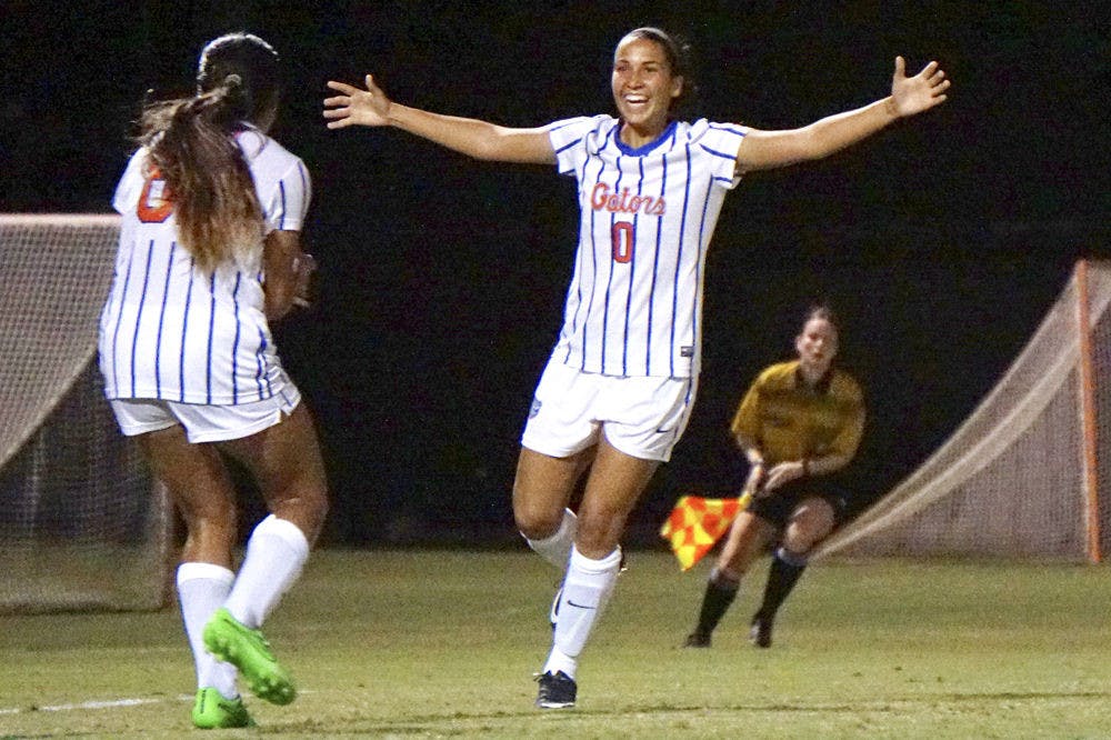<p>UF midfielder Briana Solis (0) celebrates with defender Rachelle Smith after Solis scored her first career goal.</p>