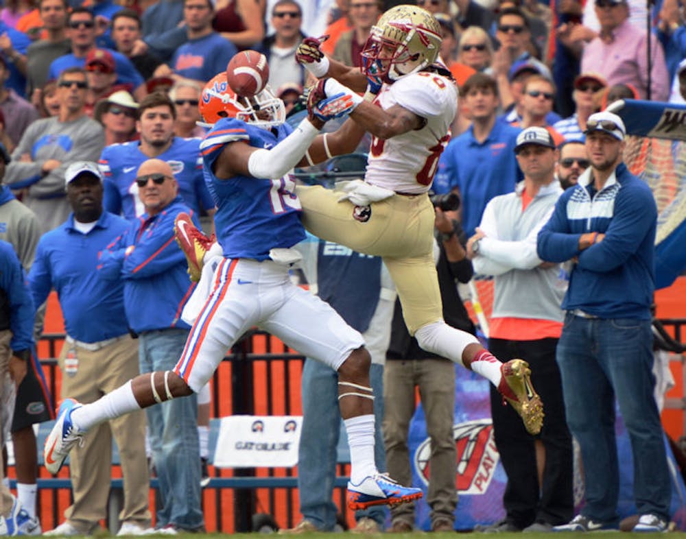 <p>Loucheiz Purifoy blocks Florida State junior wide receiver Rashad Greene from an attempted pass during Florida’s 37-7 loss to Florida State on Saturday in Ben Hill Griffin Stadium.</p>