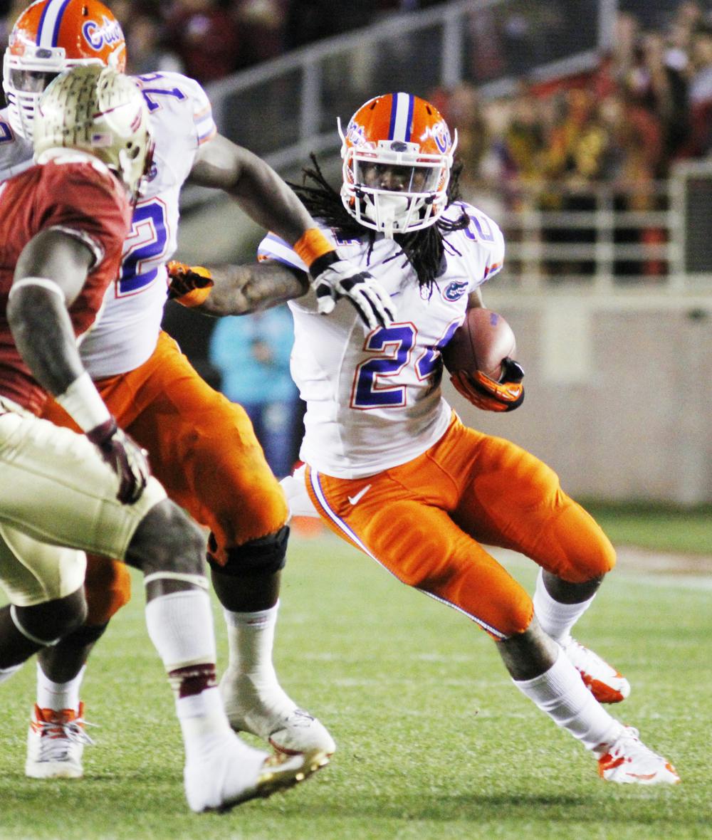 <p>Running back Matt Jones runs the ball during UF’s 37-26 win against FSU on Nov. 24. Jones missed the start of UF’s camp due to a viral infection.</p>