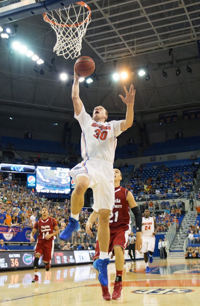 Jacob Kurtz attempts a basket during Florida’s 110-88 victory against Florida Southern in an exhibition game on Friday in the O’Connell Center. Kurtz, who is a walk-on, scored 11 points on 5-of-6 shooting and recorded nine rebounds.