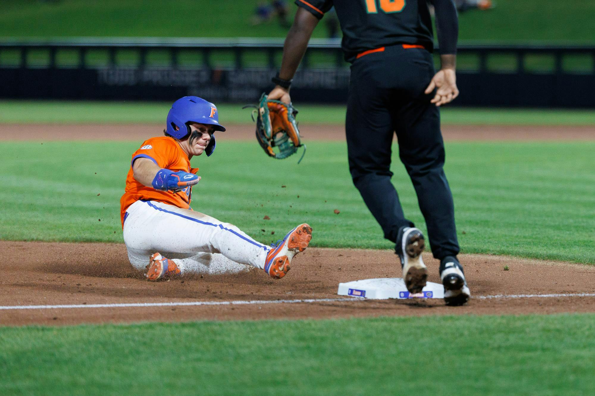 Florida outfielder Bllake Cyr (5) slides into third base against Infielder Jay Campbell (10) during an NCAA baseball game against Florida A&M University, Wednesday, March 4, 2026, in Gainesville, Fla.