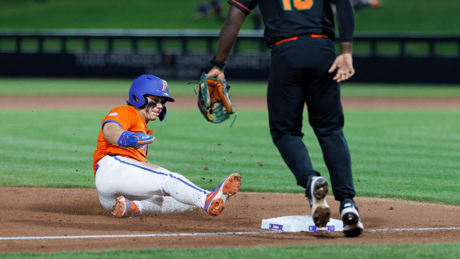 Florida outfielder Bllake Cyr (5) slides into third base against Infielder Jay Campbell (10) during an NCAA baseball game against Florida A&M University, Wednesday, March 4, 2026, in Gainesville, Fla.