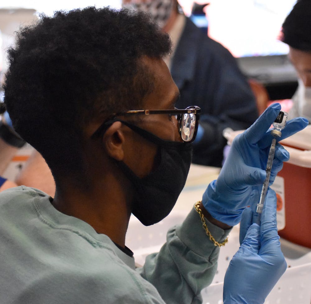 A UF pharmacy student prepares the COVID-19 vaccine before it is administered Friday, Feb.5, 2021.