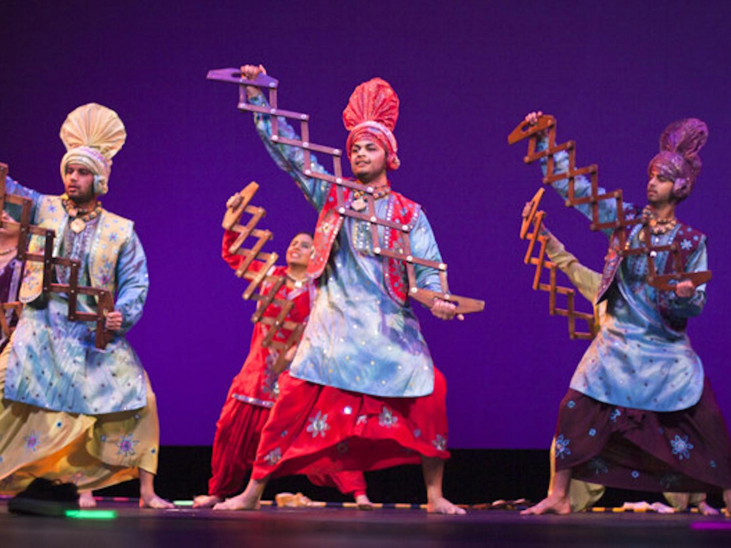 Members of Punjab Di Asli Pehchaan perform at the Indian Student Association's Diwali Show on Saturday night at the Curtis M. Phillips Center for the Performing Arts. The group is a competitive team of dancers from around Florida.