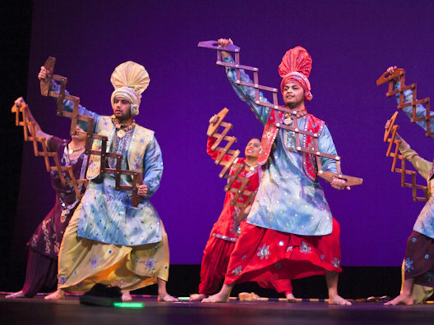 Members of Punjab Di Asli Pehchaan perform at the Indian Student Association's Diwali Show on Saturday night at the Curtis M. Phillips Center for the Performing Arts. The group is a competitive team of dancers from around Florida.
