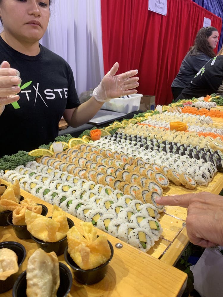 Taste of Greater Gainesville attendees samples sushi provided by Taste, a local restaurant that serves Pan-Asian cuisine.