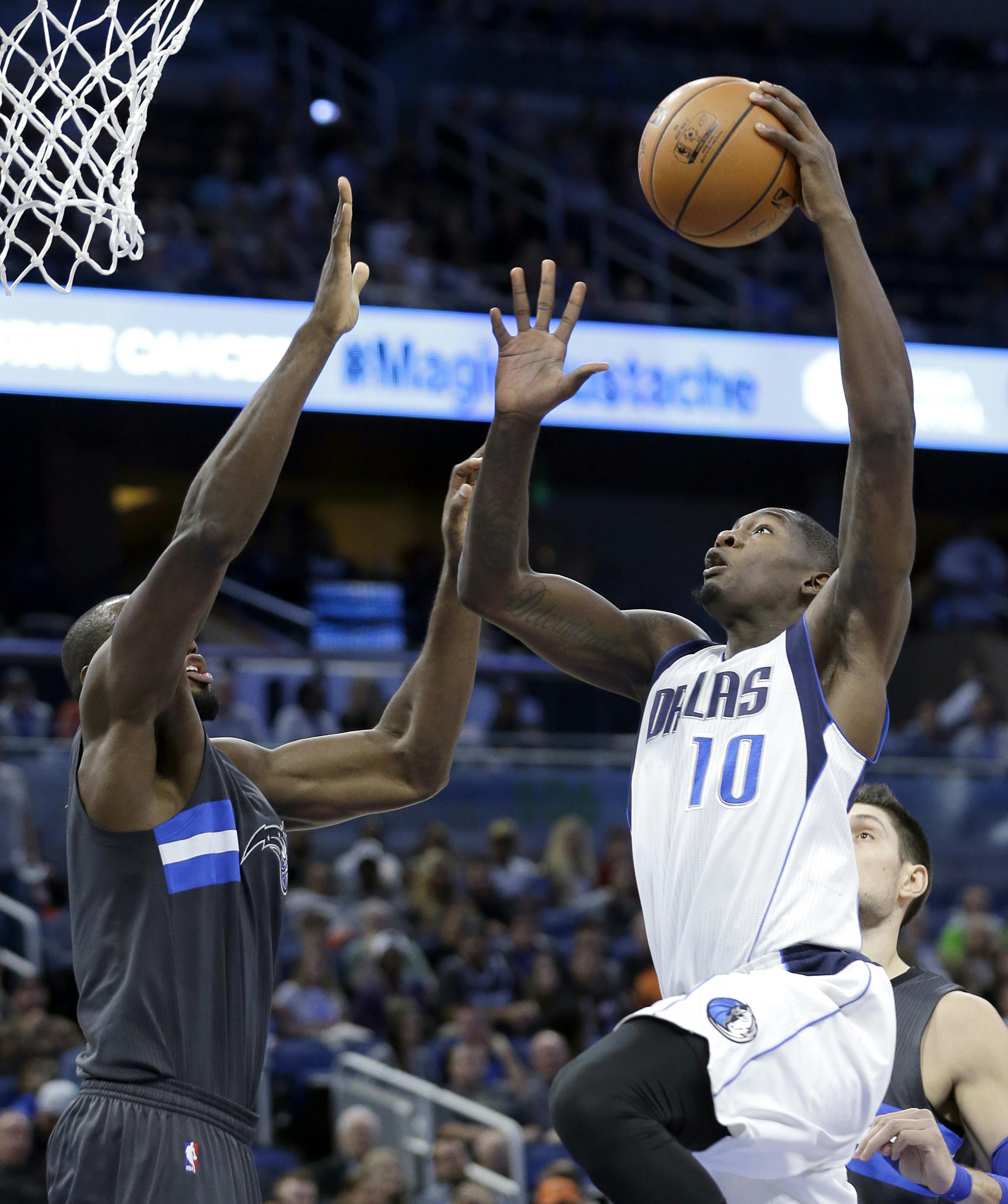 Dallas Mavericks' Dorian Finney-Smith (10) takes a shot over Orlando Magic's Serge Ibaka, left, during the first half of an NBA basketball game, Saturday, Nov. 19, 2016, in Orlando, Fla. (AP Photo/John Raoux)