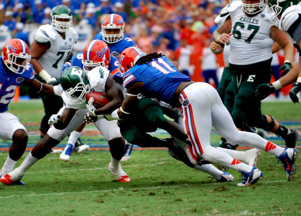 <p>Redshirt senior Neiron Ball tackles an Eagles player during Florida's 65-0 victory against Eastern Michigan on Saturday at Ben Hill Griffin Stadium.</p>