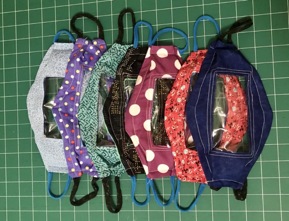 The masks are made from cotton quilting fabric, clear vinyl and T-shirt yarn.