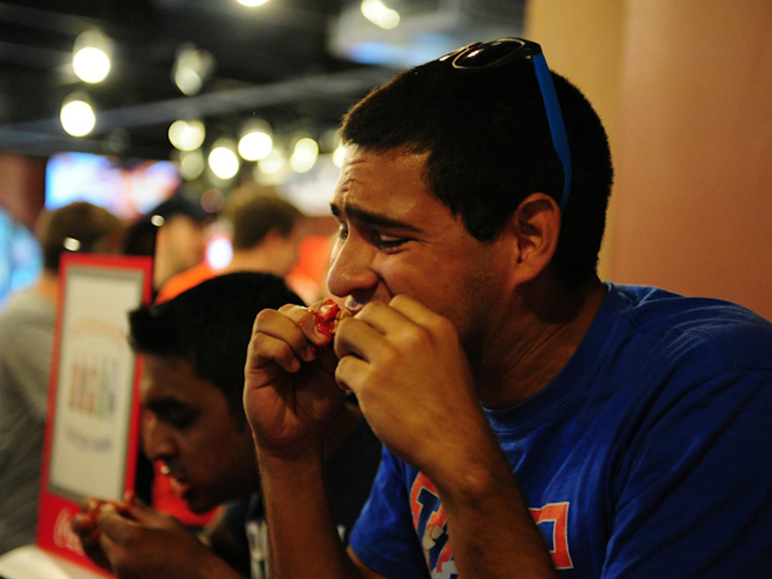 Jorge Araujo, a 21-year-old mechanical and aerospace engineering senior, and Amit Gupta, a Ph.D. candidate in electrical engineering, participate in the Munchies 420 ghost pepper chili wing eating challenge. Neither could finish his plate.
