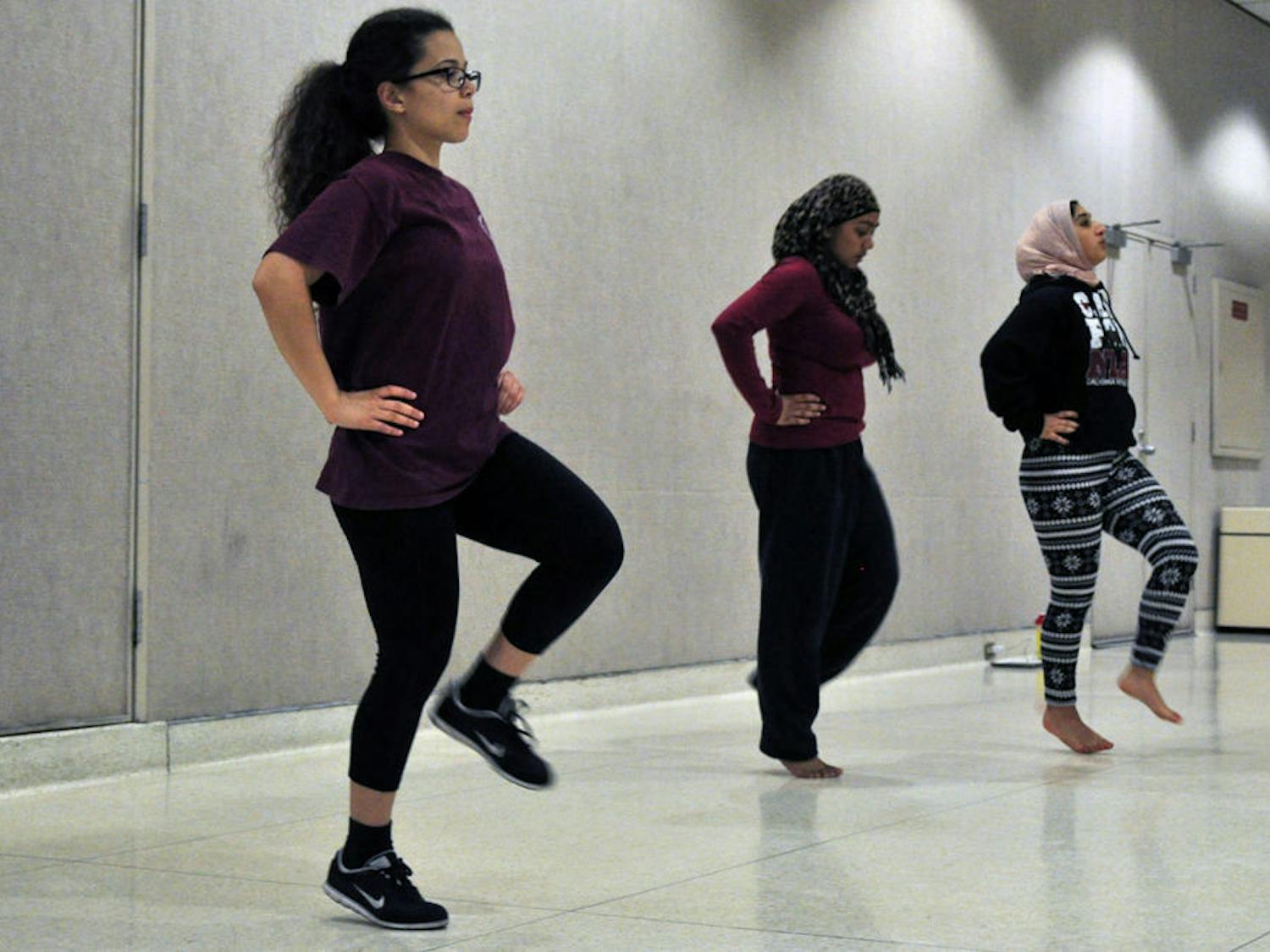 From left: Christine Diaz, a 22-year-old UF psychology senior, Bushra Rashid, a 20-year-old UF sociology junior, and Rana Al-Nahhas, a 20-year-old UF psychology sophomore, practice a dance to a portion of Beyonce's "Flawless" at the Reitz Union on Monday. They'll perform the dance at Pakistani Students' Association's 19th annual cultural show "Humara Saturday Night Live," featuring Pakistani-Dutch singer Imran Khan.