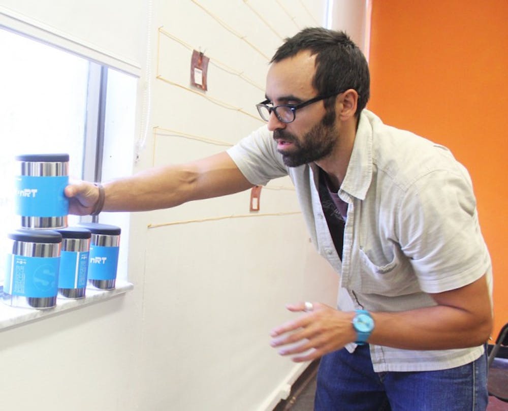 <p>Jorge Pérez Gallego, 32, sets up for his exhibit “SCIENCESTORE” at the College of Fine Arts’ Focus Gallery on Tuesday. The gallery is located in Fine Arts C.</p>