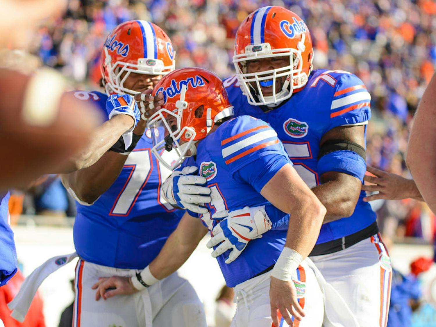 Max Garcia and Chaz Green celebrate with Mike McNeely after his touchdown during Florida's 38-20 win against Georgia on Saturday