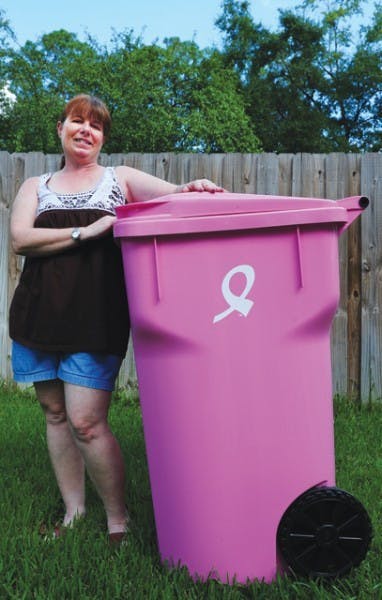 JoAnn Alarid poses with a pink trash cart bought to support the 2010 Making Strides Against Breast Cancer walk.