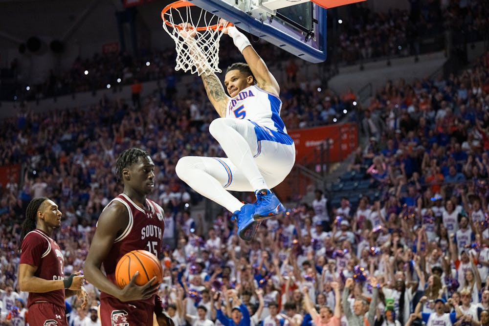 Florida Gators guard Will Richard (5) dunks the ball during a basketball game against South Carolina on Saturday, Feb. 15, 2025, in Gainesville, Fla.