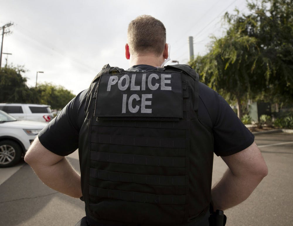 <p>FILE - In this July 8, 2019, file photo, a U.S. Immigration and Customs Enforcement (ICE) officer looks on during an operation in Escondido, Calif. International students will be forced to leave the U.S. or transfer to another college if their schools offer classes entirely online this fall, under new guidelines issued Monday by federal immigration authorities. The guidelines, issued by U.S. Immigration and Customs Enforcement, provide additional pressure for campuses to reopen even amid growing concerns about recent spread of COVID-19 among young adults. (AP Photo/Gregory Bull, File)</p>