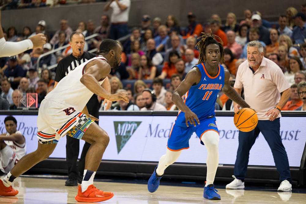 Florida Gators guard Denzel Aberdeen (11) dribbles the ball in a basketball game against Auburn University on Feb. 8, 2025, in Auburn, Ala.