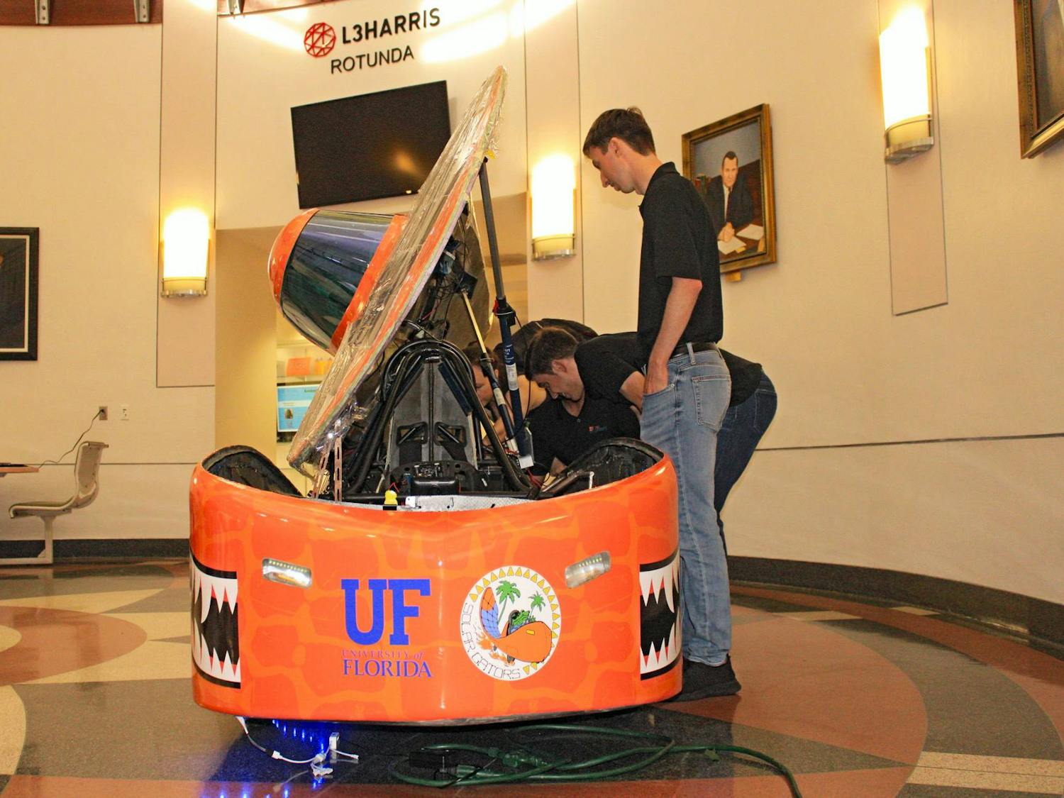 After years of hard work and engineering obstacles, the Solar Gators revealed their newest solar-powered car at UF’s New Engineering Building Thursday. The car is set to compete at the Formula Sun Grand Prix at Topeka, Kansas, throughout the week.
Designed and assembled completely by UF students, the “Sunrider” can reach speeds up to 50 mph, and a single battery pack can power it through 200 miles.
The week-long competition consists of four days of scrutineering, where experts test and inspect every piece of the vehicle, followed by three days of racing. It’s a race of endurance where previous winners reached 700 miles through multiple battery packs. The team will compete against 14 other groups from across the United States and Canada. Irene Chung, president-elect of Solar Gators, said winning this competition will qualify them for larger competitions such as the American Solar Challenge. However, more hurdles await them at the racetrack, she said.
“As you start driving,” she said, “you start seeing things that you’ve never seen before, and you’ve got to debug and problem solve on the fly.”