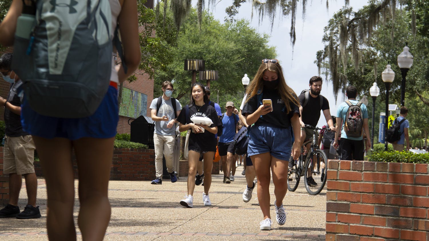 Students walk through Turlington Plaza in between classes on Monday, Aug. 23, 2021. Monday marked the beginning of the Fall semester at UF.
